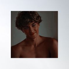 an image of a man with no shirt on smiling at the camera, in front of a white background poster