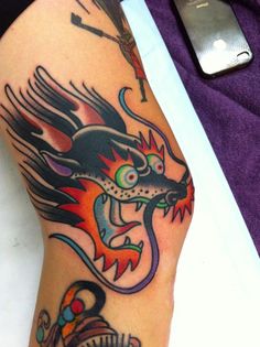 a dragon tattoo on the leg of a person