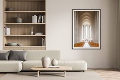 a living room with a couch, coffee table and bookshelf on the wall