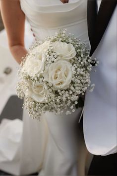 the bride and groom are holding their wedding bouquet