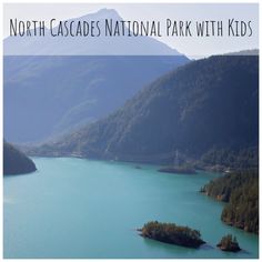 a lake surrounded by mountains with the words north cascades national park with kids on it