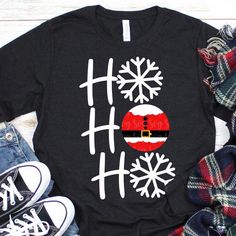 a black shirt with white snowflakes on it and santa hat in the middle