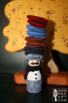 there is a small toy that has been made to look like a man with many hats on