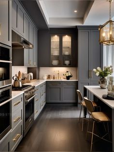 a kitchen with gray cabinets and white counter tops, gold accents on the trimmings