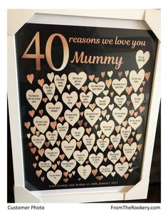 a framed sign with hearts on it that says, 40 reason we love you mommy