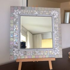 a mirror sitting on top of a wooden table