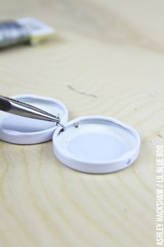 a pair of scissors are sitting on a wooden surface