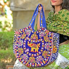 Eco-Friendly hand bag is made of a cotton with fine rajasthani embroidery with mirror work design on it that makes it durable enough to tote around all your things - **High-Quality Material Made of durable cotton with fine Rajasthani embroidery and mirror work, ensuring long-lasting use. - **Unique Design Features intricate embroidery on both sides, showcasing traditional Rajasthani craftsmanship. - **Generous Size With a length of 37 cm and a width of 50 cm, it provides ample space for all your Traditional Blue Bags For Festivals, Bohemian Multicolor Zari Work Bag, Traditional Multicolor Cotton Shoulder Bag, Bohemian Multicolor Bags With Zari Work, Traditional Cotton Shoulder Bag For Daily Use, Traditional Blue Shoulder Bag For Festivals, Blue Embroidered Bag For Festivals, Traditional Blue Embroidered Shoulder Bag, Traditional Multicolor Cotton Bag