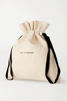 a canvas bag with a black ribbon and net - a - porter logo