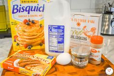 ingredients to make pancakes sitting on top of a counter next to a bottle of milk