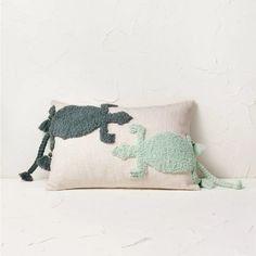 a pillow with an elephant and turtle on it