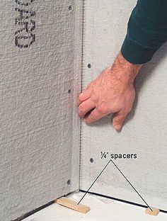 a man is measuring the height of a wall