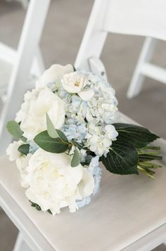 a bouquet of flowers sitting on top of a white chair