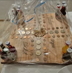 a wooden board with coins and bottles on it