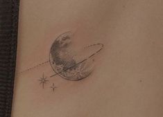 a woman's stomach with a small tattoo on the side of her belly and an airplane flying in front of it