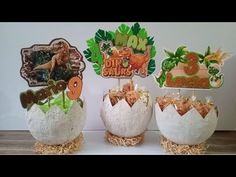 three decorated eggs sitting on top of hay