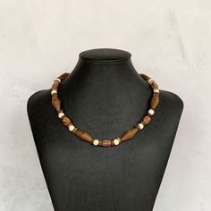 This bohemian wood necklace is perfect for everyday wear!  It was hand beaded using a stylish mix of geometric wooden beads in a variety of shapes and colors including shades of brown, tan and cream. The necklace measures approximately 19 inches in length and is securely fastened with a silver clasp.  Perfect for men or women!  Length can be adjusted if needed - just ask! Wood represents a sense of earthiness, spirituality, creativity, liberty, prosperity, health, and natural touch.  Perfect for Spiritual Necklace With Wooden Beads, Spiritual Wooden Bead Necklace, Spiritual Wooden Beads Necklace, Rustic Brown Wooden Bead Necklaces, Necklace Everyday, Necklace Wood, Necklace Mens, Wood Bead Necklace, Wooden Necklace