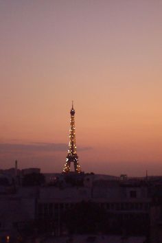 the eiffel tower is lit up at night with lights on it's sides