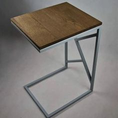 a wooden table sitting on top of a metal frame