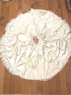 a white dress sitting on top of a wooden floor