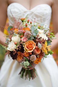 a bride holding a bouquet of flowers in her hands