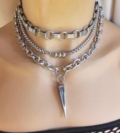 This handmade chunky stainless steel chain layered necklace set with spike is a stunning piece of jewelry that is perfect for those who love bold and edgy accessories. This is one necklace that is adjustable with a built-in extender from approximately 15" to 18",  All the chains of the necklace are made of sturdy stainless steel, making it completely hypoallergenic, waterproof, and non tarnish. It will look exactly like this forever!  This necklace set is an excellent handmade gift for someone special. It is a perfect choice for those who love alternative and goth styles, as well as anyone who wants to make a statement with their jewelry.. Edgy Chain Jewelry For Gifts, Edgy Chain Jewelry For Gift, Edgy Chain Jewelry As Gift, Edgy Chain Jewelry Gift, Trendy Multi-strand Chunky Chain Jewelry, Edgy Silver Jewelry With Chunky Chain, Silver Layered Necklace With Chunky Chain As Gift, Chunky Chain Choker Jewelry For Layering, Handmade Edgy Metal Necklaces