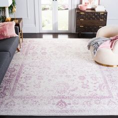 a living room with a couch, chair and rug