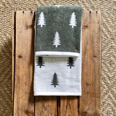 a towel with trees on it sitting on top of a wooden table