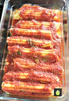 lasagna casserole in a glass baking dish with red sauce and cheese