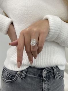 a woman wearing a diamond ring on her finger