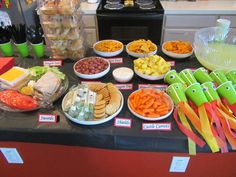 a buffet table filled with different types of food and snacks on it's sides