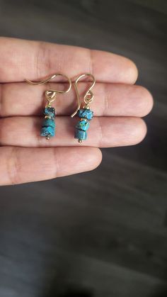 These exquisite earrings are crafted from top-quality, natural turquoise with an organic cut and finish, measuring approximately 6 mm in width. Despite their petite size, their vibrant color and accent beads make them stand out and capture attention. These earrings can be customized in sterling silver, gold-filled, or rose gold-filled finishes. With an approximate length of 1 inch, they are ideal for those who appreciate minimalistic jewelry Everyday Turquoise Gemstone Earrings, Dainty Turquoise Earrings For Gift, Dainty Turquoise Earrings As Gift, Minimalist Turquoise Wire Wrapped Earrings, Handmade Minimalist Turquoise Jewelry, Rustic Drop Earrings Jewelry For Gift, Rustic Drop Earrings Jewelry Gift, Rustic Wire Wrapped Earrings For Gift, Rustic Dangle Earrings As A Gift