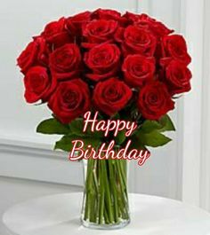 a vase filled with red roses on top of a table