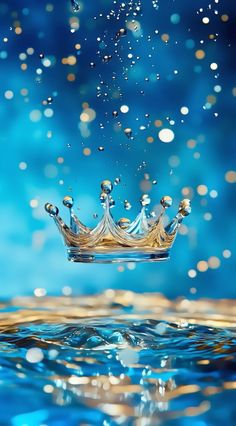 a crown floating in the water on top of blue and gold background with small bubbles