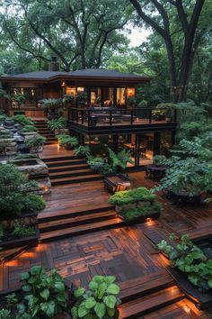 an outdoor deck with lights and plants on it, surrounded by trees in the background