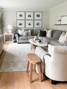 a living room filled with furniture and pictures on the wall