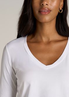 About Our Long Sleeve Scoop V-Neck Tee Shirt for Tall Women There’s something beautiful about basics. They’re the building blocks of your wardrobe and the staples of your everyday outfits. Your essentials should always fit perfectly, so we set out to create the fundamental Long Sleeve Scoop V-Neck Tee shirt for tall women. This women’s tall top has been tailored for your shape and height with extra-long sleeves and an extended hemline. The front features a casual scoop v-neck while the rear hem Basic Spring Loungewear Tops, Everyday V-neck Top In Specific Color, Basic Scoop Neck Tops, Basic V-neck Loungewear Tops, Simple Stretch Tops For Layering, Basic Stretch Tops For Everyday, White V-neck Top For Everyday Wear, White V-neck Long Sleeve Top, Versatile V-neck Stretch Long Sleeve Top