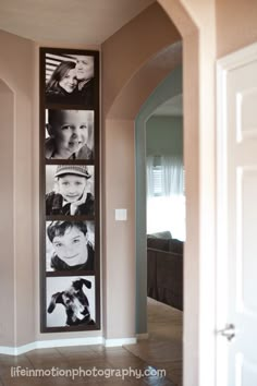 a hallway with pictures hanging on the wall and tiled flooring in front of it