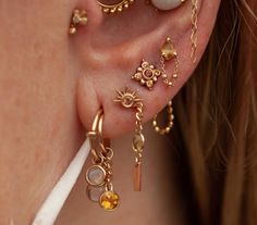 a close up of a person with ear piercings on their ears and behind the ear