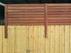 a wooden fence that is next to a building