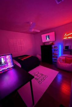 a room with purple lighting and a bed