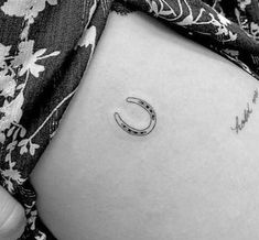 a woman's stomach with a crescent tattoo on her belly and the word love written in cursive writing