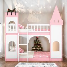 a pink and white bunk bed with a christmas tree on the bottom shelf in front of it