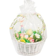 a white basket filled with easter eggs and flowers