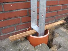 there is a potted planter with two metal poles sticking out of the ground