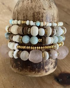 ✨💛 peaceful beachy stack✨ pale pinks, rustic browns, cool blues and pops of gold in this 5 piece bead stack.  peaceful and calming color combo for our fast paced hectic world.  pairs with other rhinestone cuffs so nicely. listing is for the 5 beaded bracelets shown, the cross and rhinestone cuffs are sold separately in my shop, for dislplay purposes only. message with questions shipping is ground tracked insured Earthy Beaded Bracelets For Beach, Earthy Natural Stone Beaded Bracelets For Beach, Beige Bohemian Beaded Bracelets, Earthy Hand Wrapped Bracelets For Beach, Earthy Hand-wrapped Bracelets For The Beach, Bohemian Beige Bracelets With Round Beads, Bohemian Stackable Wrap Bracelet For Beach, Bohemian Beaded Bracelets With Natural Stones For Beach, Pink Bohemian Beaded Bracelets For Healing