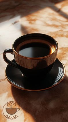 a cup of coffee sitting on top of a saucer next to a black plate