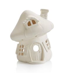 a white ceramic house shaped like a mushroom