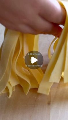 someone is peeling the edges of some pasta