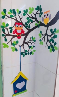 the bathroom is decorated with owls and a birdhouse hanging from a tree branch that has leaves on it